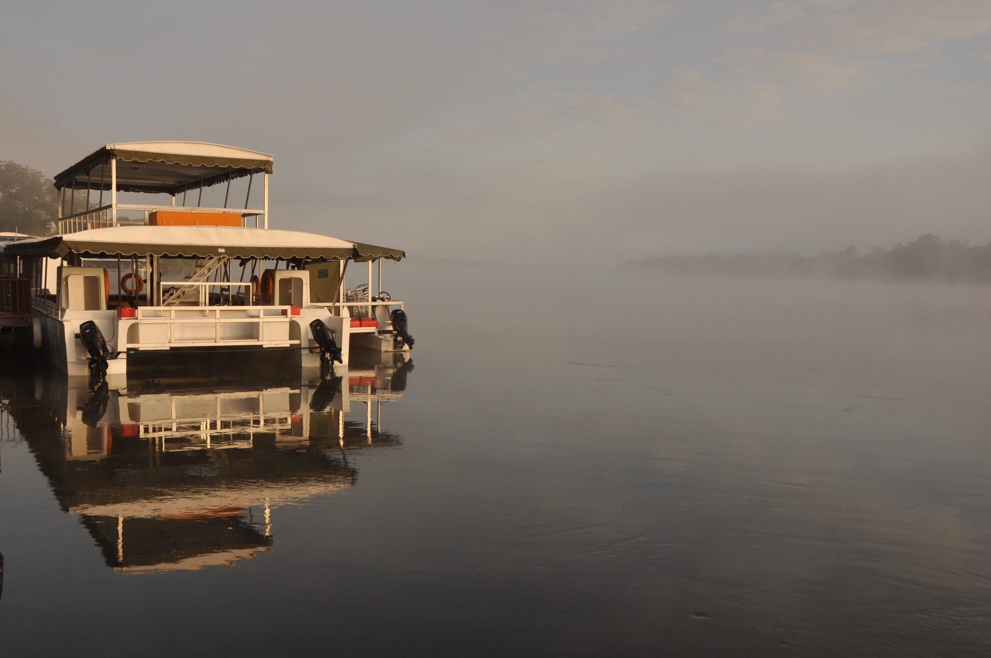 Guests on a Zambezi river cruise at golden hour